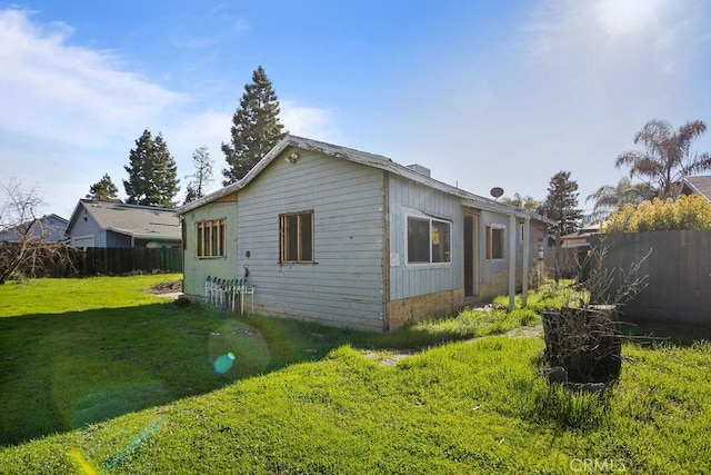 view of side of property with a yard