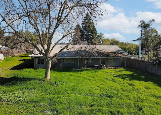 back of house with a lawn