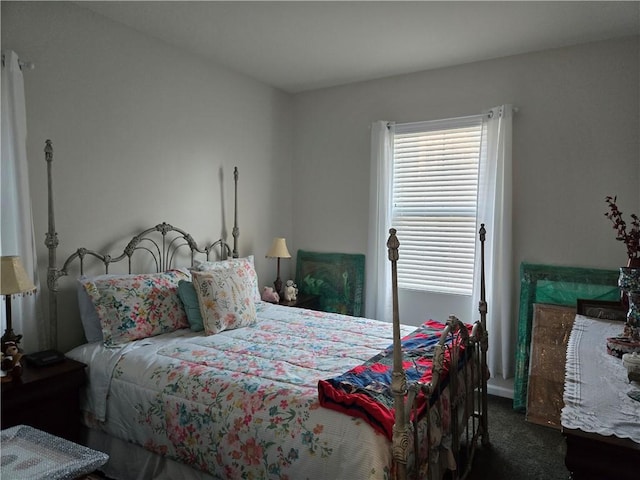 bedroom featuring dark colored carpet