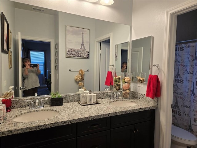 bathroom featuring vanity and toilet