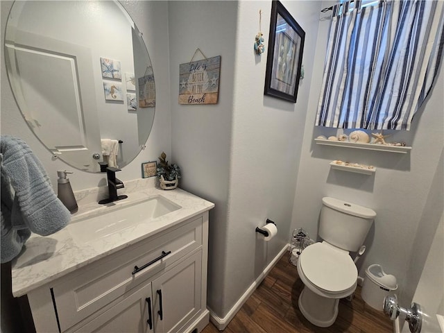 bathroom featuring vanity, toilet, and wood-type flooring