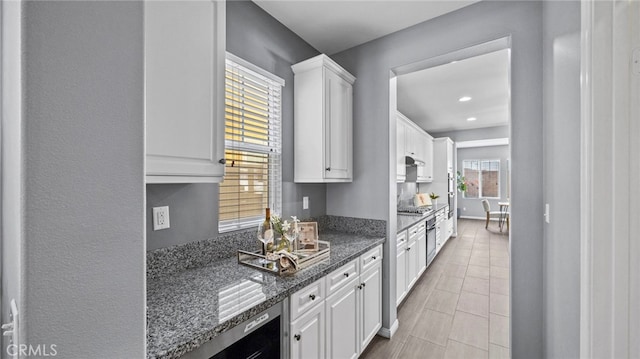 kitchen featuring white cabinetry, beverage cooler, stainless steel gas cooktop, and dark stone countertops