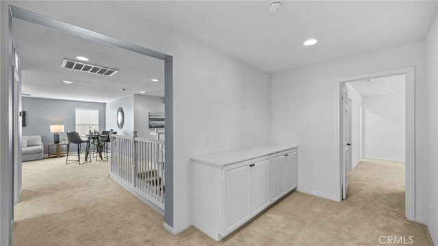 hallway with light colored carpet