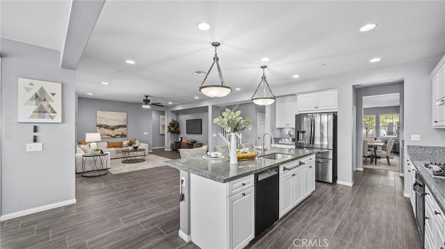 kitchen with stainless steel refrigerator with ice dispenser, sink, white cabinetry, black dishwasher, and an island with sink