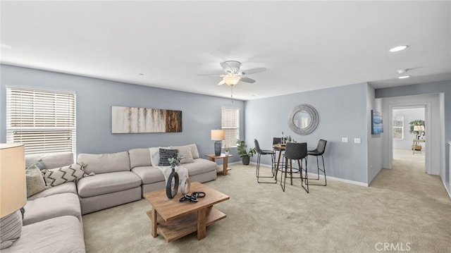 living room featuring light colored carpet and ceiling fan