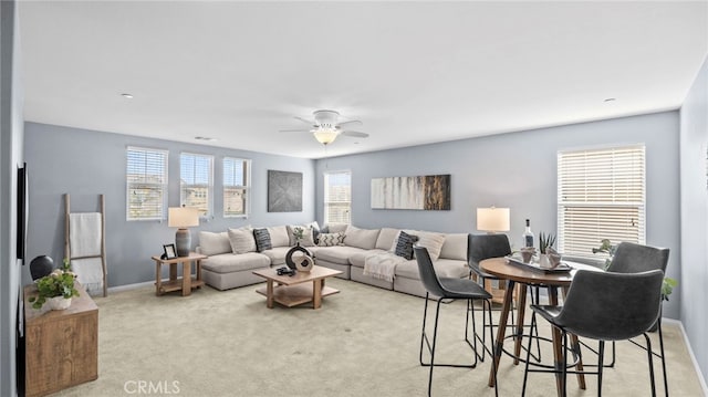 living room with light colored carpet and ceiling fan