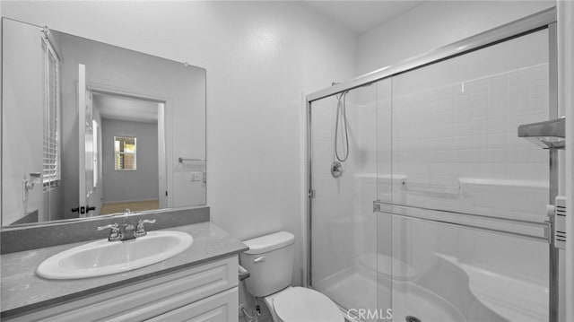 bathroom featuring vanity, toilet, and walk in shower