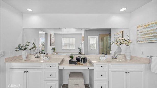 bathroom with a shower with door and vanity