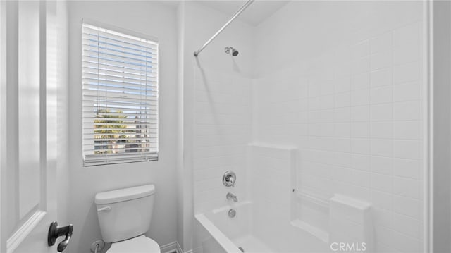 bathroom featuring shower / tub combination and toilet