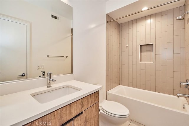 full bathroom with toilet, vanity, and tiled shower / bath