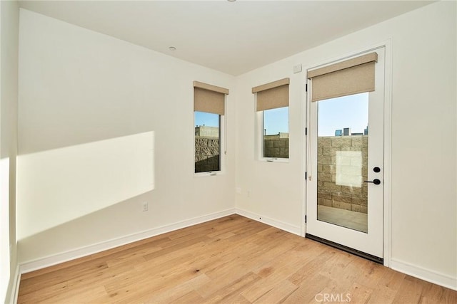 empty room with light hardwood / wood-style flooring