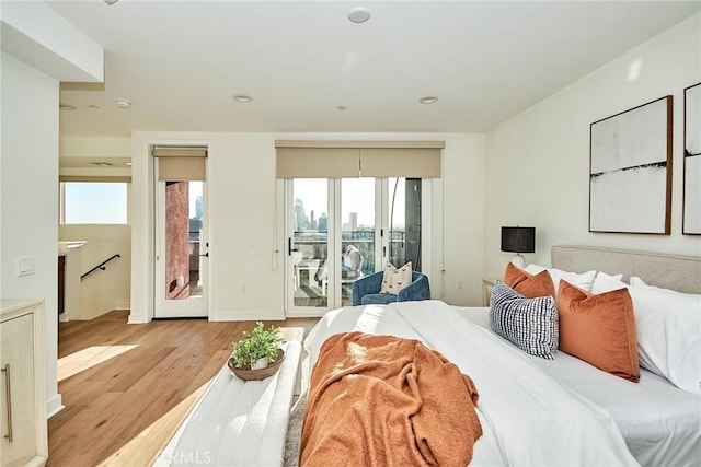 bedroom featuring light hardwood / wood-style floors and access to outside