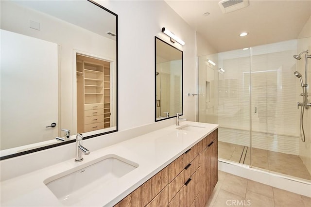 bathroom featuring vanity, tile patterned floors, and a shower with shower door