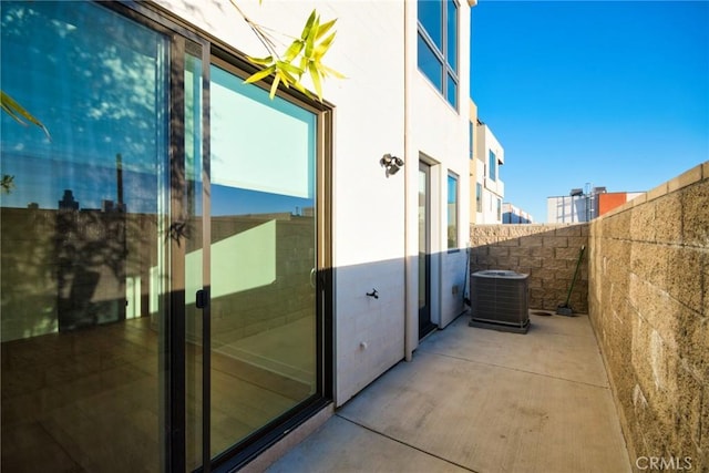 view of property exterior with a patio area and central air condition unit