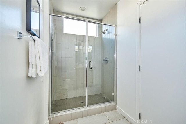 bathroom featuring tile patterned floors and a shower with door