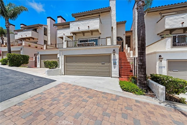 mediterranean / spanish-style house featuring a balcony and a garage