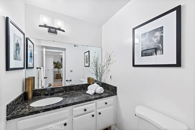 bathroom with toilet and vanity