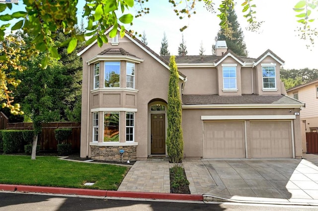 view of front of home featuring a front yard and a garage