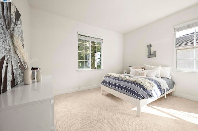 bedroom featuring light colored carpet