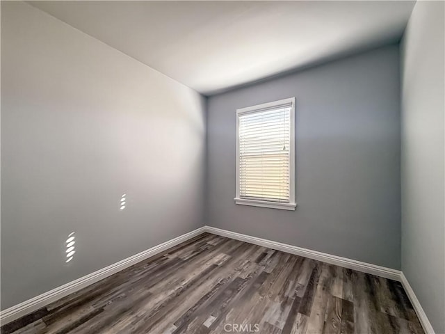 unfurnished room featuring dark hardwood / wood-style flooring