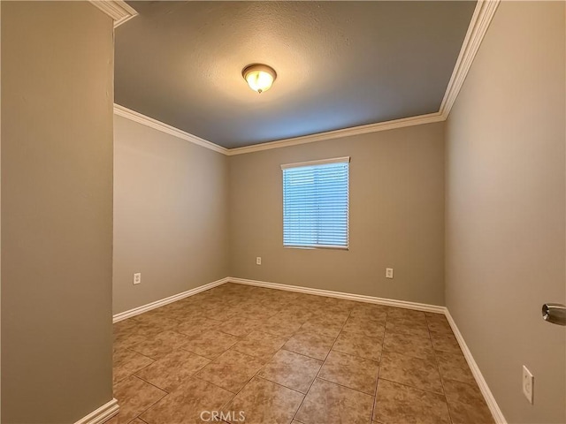 empty room with crown molding and light tile patterned floors