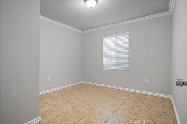 unfurnished room with ornamental molding and light tile patterned floors