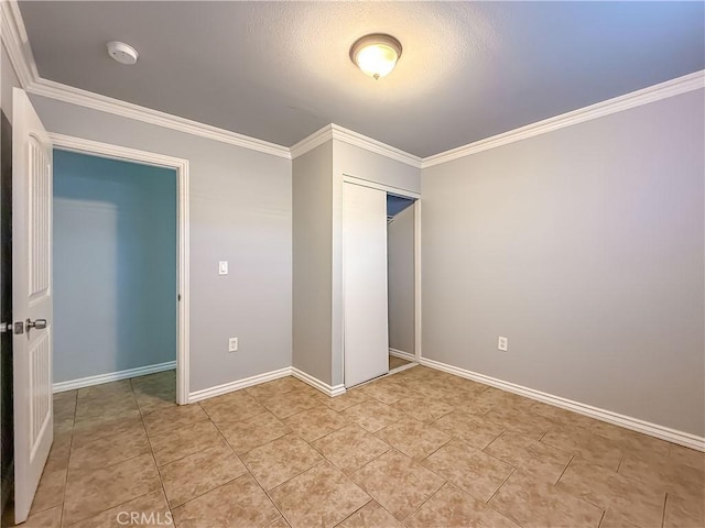 unfurnished bedroom with crown molding, light tile patterned flooring, and a closet