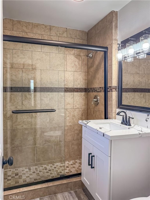 bathroom featuring walk in shower and vanity