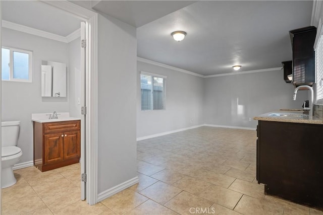 interior space featuring sink and ornamental molding