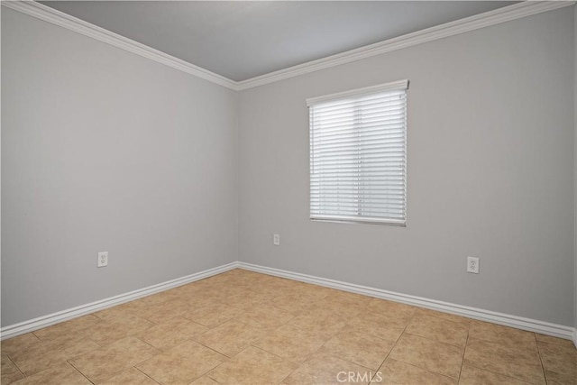 tiled spare room featuring crown molding