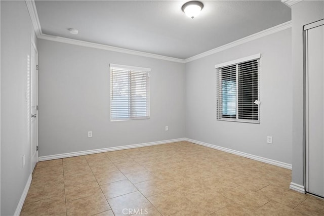 tiled spare room featuring ornamental molding