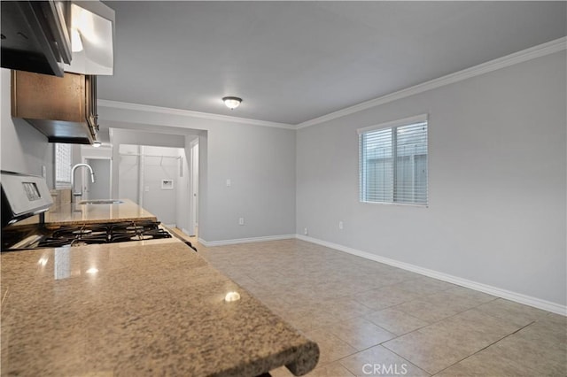 kitchen featuring stove, sink, ornamental molding, and light tile patterned flooring