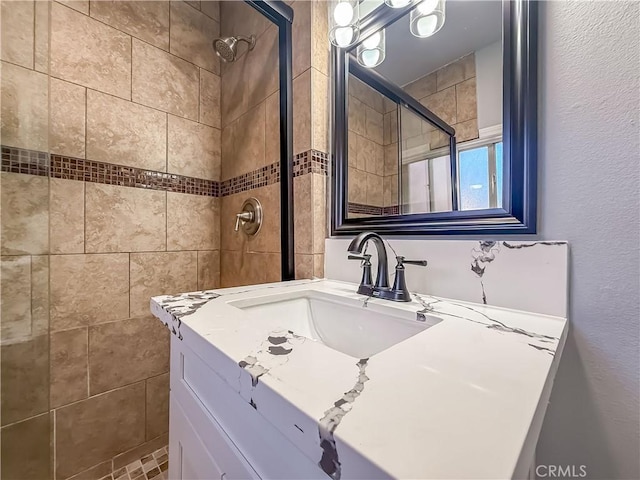 bathroom featuring vanity and a tile shower