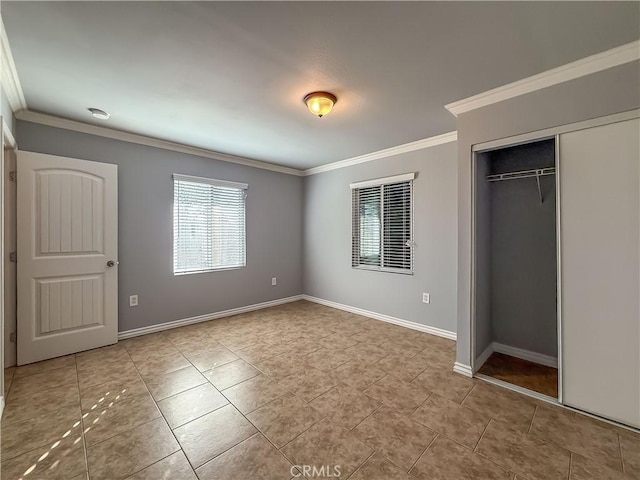 unfurnished bedroom featuring crown molding, a closet, and light tile patterned floors