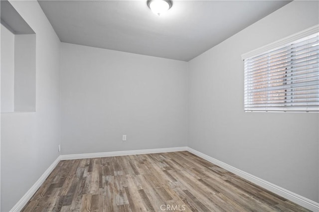 spare room with hardwood / wood-style flooring