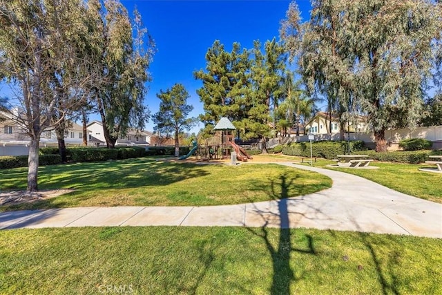 view of community with a playground and a yard