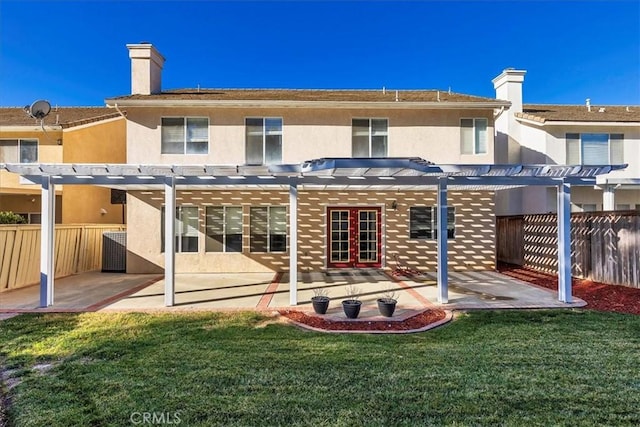 back of house featuring a pergola, a patio area, a lawn, and central AC unit