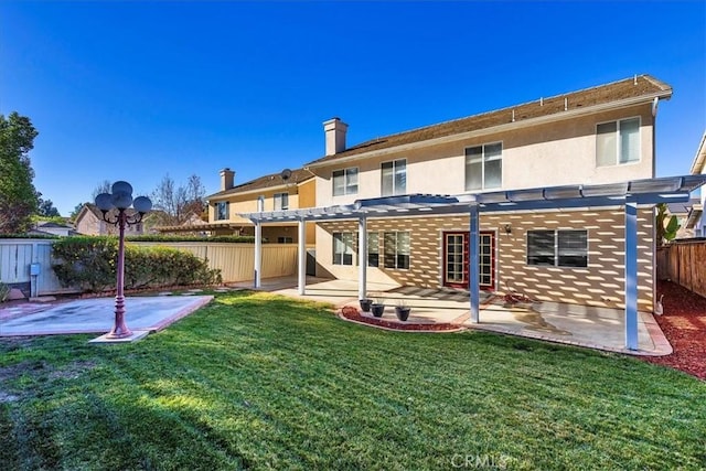 back of property featuring a pergola, a yard, and a patio