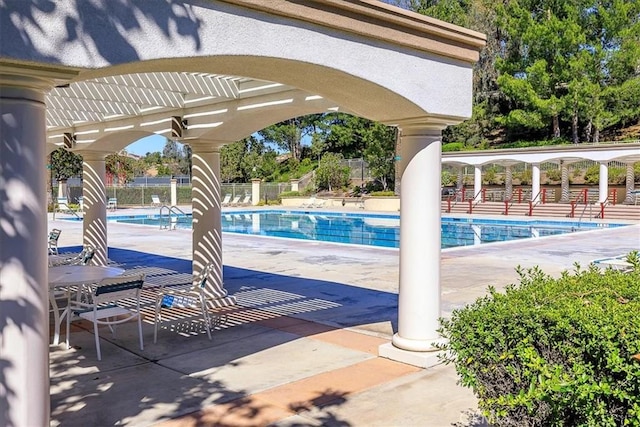 view of swimming pool featuring a pergola and a patio