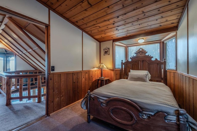 carpeted bedroom featuring wood walls, lofted ceiling, and wooden ceiling