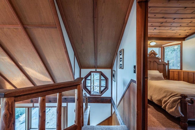 interior space featuring lofted ceiling, wooden ceiling, and wooden walls