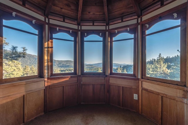 unfurnished sunroom featuring a mountain view