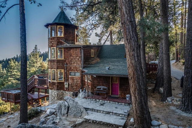 back of property featuring a wooden deck