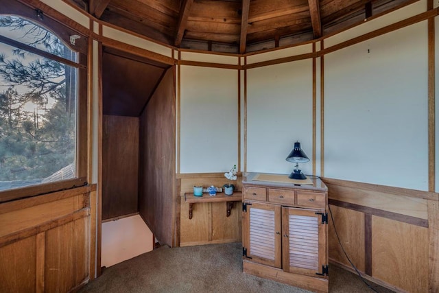 interior space featuring lofted ceiling with beams and wooden ceiling