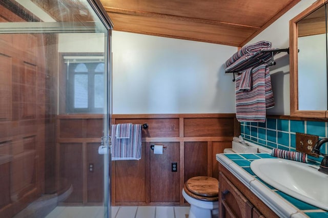 bathroom featuring an enclosed shower, vanity, toilet, and tile patterned flooring