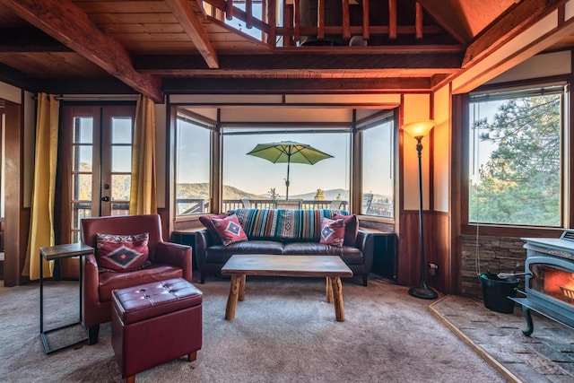 sunroom / solarium with beamed ceiling, a wood stove, and wood ceiling