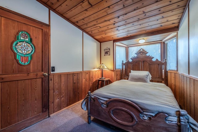 bedroom with carpet floors, wooden walls, lofted ceiling, and wood ceiling