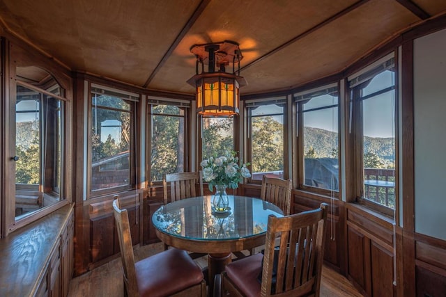 sunroom / solarium featuring a mountain view and wood ceiling