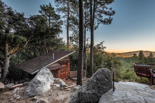 exterior space with a deck with mountain view