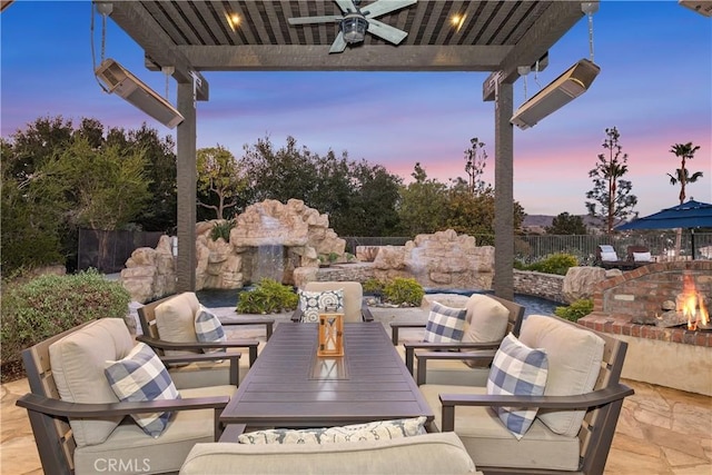 patio terrace at dusk featuring an outdoor living space and ceiling fan